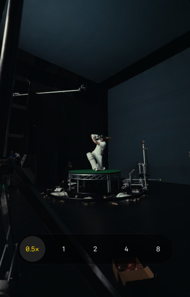 Zoomed-in close-up of cricketer Marnus Labuschagne wearing a cricket helmet and white shirt against a black background. Zoom slider is set to 8x, demonstrating clear definition at any zoom range.