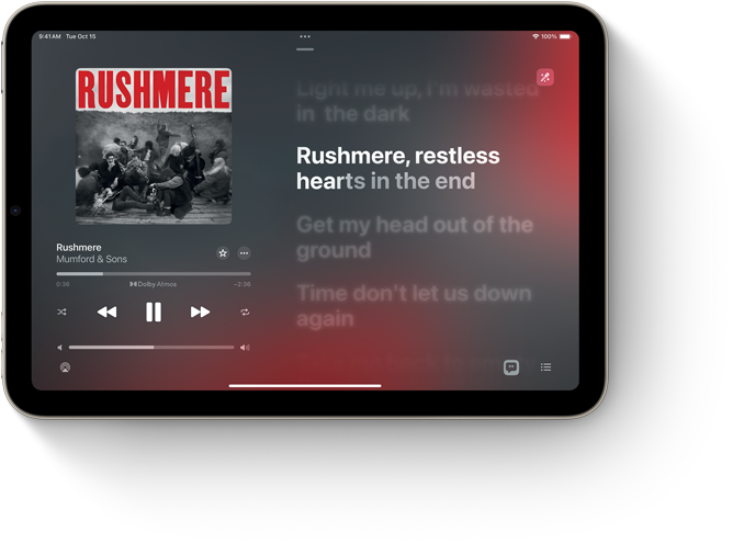 iPad mini, landscape orientation, displaying Apple Music with song lyrics.