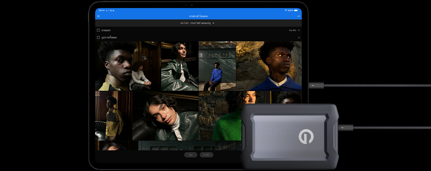 iPad Pro, front exterior, landscape orientation, space black color, connected with a cable to a USB-C external hard drive, display showing photos of models being imported to a folder called 'Campaign Shoot'