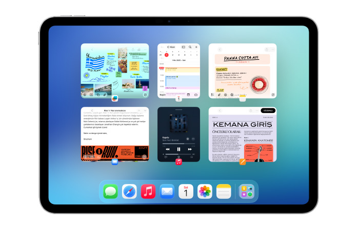 iPad, yatay pozisyonda, Takvim, Notlar, Apple Music ve Safari uygulamalarının da yer aldığı altı pencere, iki sıra halinde açık olarak gösteriliyor