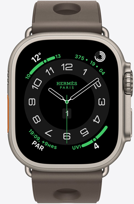 Apple Watch Hermès Ultra 3, titanium case, natural colour, Hermès Circulaire watch face, complications: weather, activity rings, PAR, UV index, right side exterior, Digital Crown, microphone, raised side button, Scub’H Diving strap, gris titane colour