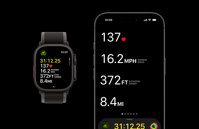 Apple Watch Ultra 3 com caixa em titânio preto, Loop Trail preto/carvão, iPhone com métricas de treino ativo abertas em ambos os dispositivos