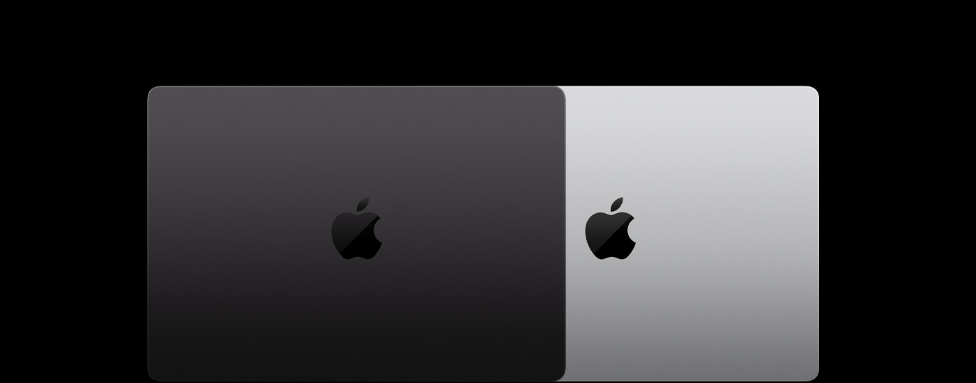 Vista de cima de dois portáteis Mac fechados, parcialmente sobrepostos.