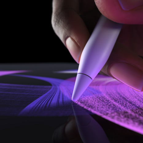 Apple Pencil Pro, side exterior, white color, hand holding pencil drawing a vibrant blue brush line