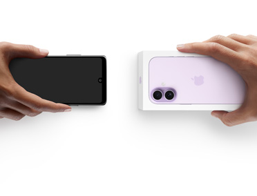 Hands exchanging phones, Android on the left without a box, on the right is a new iPhone 17 in box