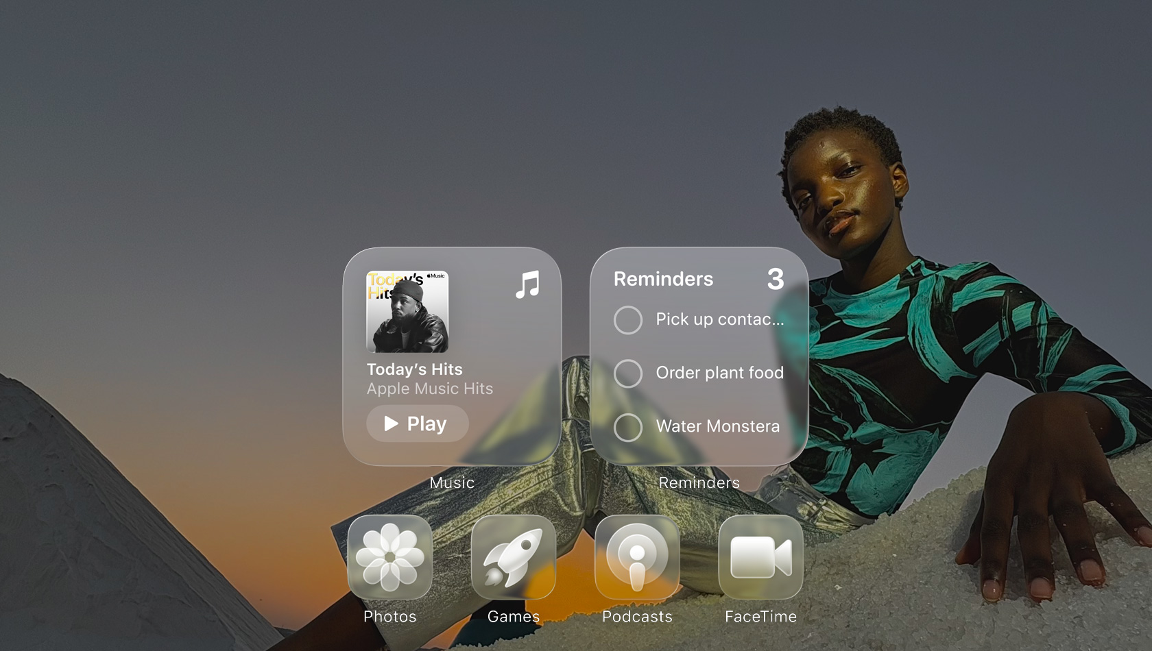 Liquid Glass display with clear app icons, like Apple Music, Reminders, Photos, Games, Podcasts and FaceTime, refracting against the wallpaper
