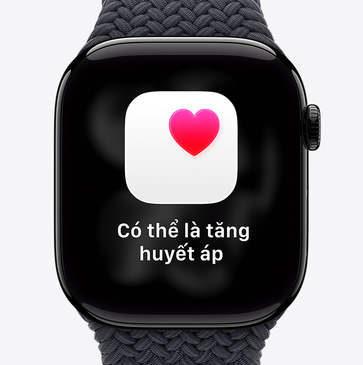 Apple Watch Series 11, aluminum case, polished Jet Black color, possible hypertension health notification, pink heart in white box, right side exterior, Digital Crown, Braided Solo Loop, black color